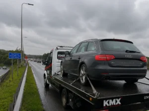 KMX Recovery transporting a broken-down Audi on a wet motorway near Bolton.