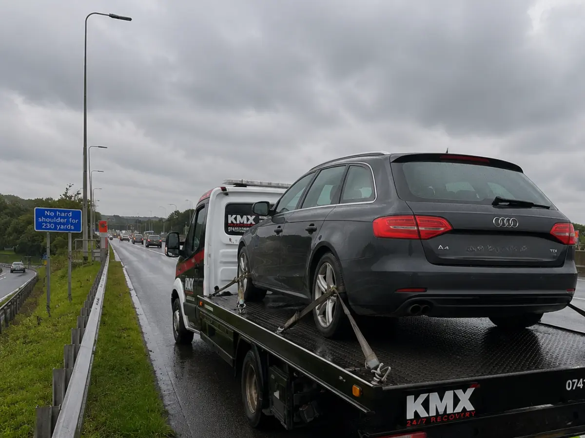 KMX Recovery transporting a broken-down Audi on a wet motorway near Bolton.